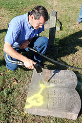 photo of a memorial stone being cleaned
